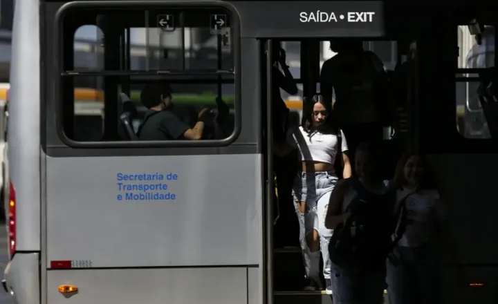 Pessoas saltando de ônibus